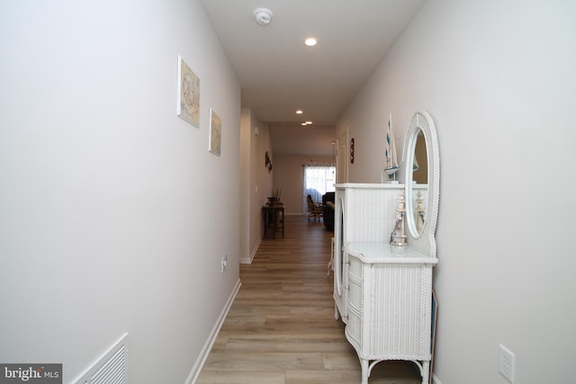 corridor featuring recessed lighting, visible vents, light wood-style flooring, and baseboards