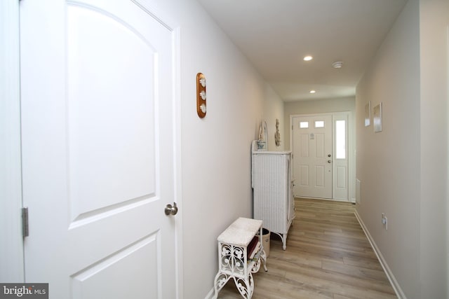 hallway with recessed lighting, light wood-type flooring, and baseboards