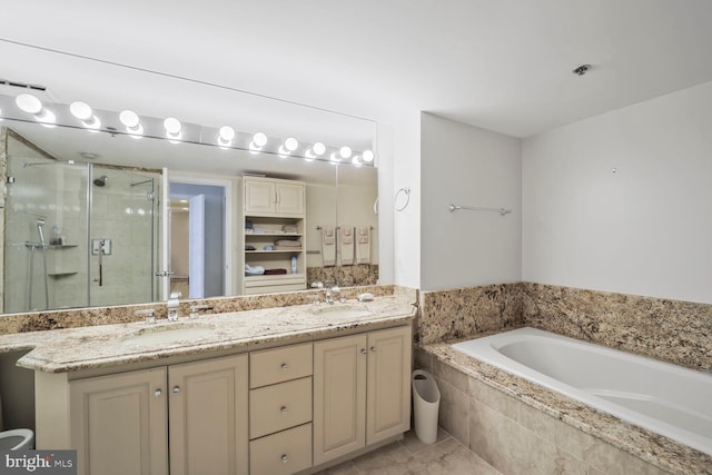 full bath with double vanity, a stall shower, a garden tub, and a sink