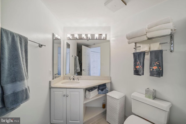 bathroom featuring toilet and vanity