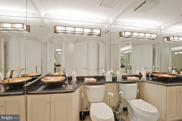 bathroom with visible vents, toilet, vanity, and ornamental molding