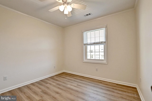 unfurnished room featuring crown molding, light wood-style flooring, baseboards, and visible vents