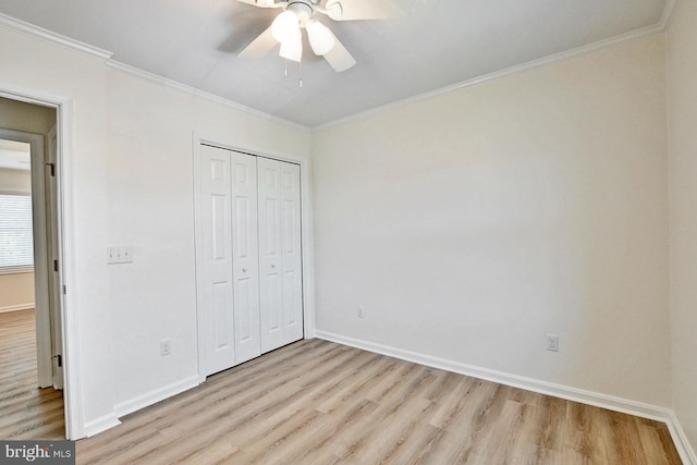 unfurnished bedroom with light wood-style floors, baseboards, and ornamental molding