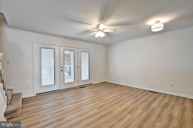 interior space with crown molding, light wood-style floors, and visible vents