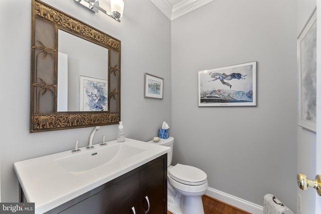 half bath with crown molding, baseboards, toilet, radiator heating unit, and vanity