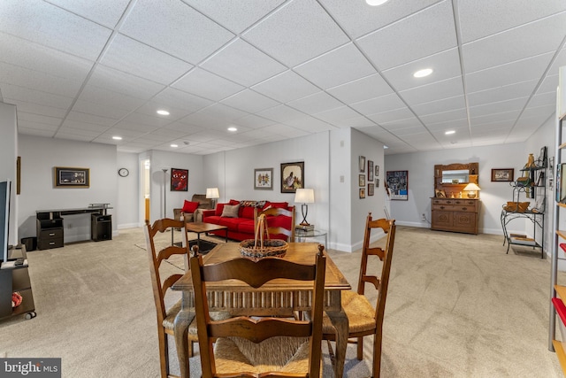 dining area with recessed lighting, baseboards, light carpet, and a drop ceiling