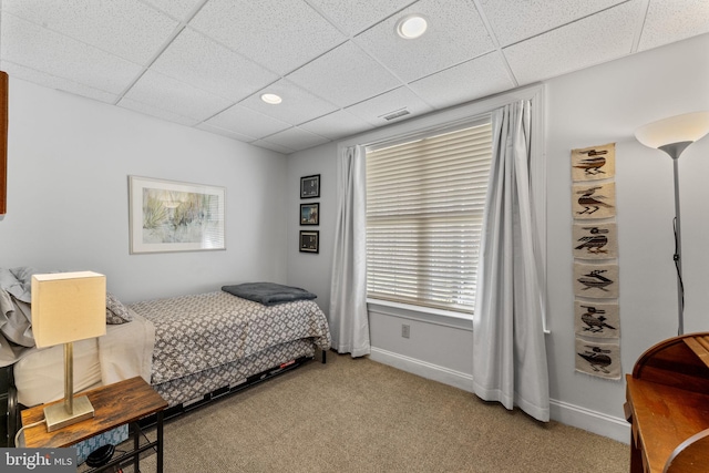 bedroom featuring carpet flooring, visible vents, baseboards, and a drop ceiling