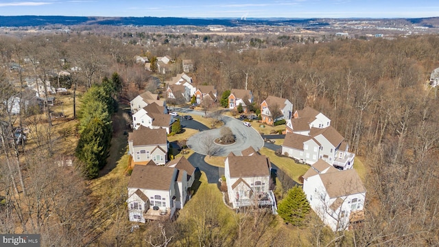 bird's eye view featuring a residential view and a wooded view