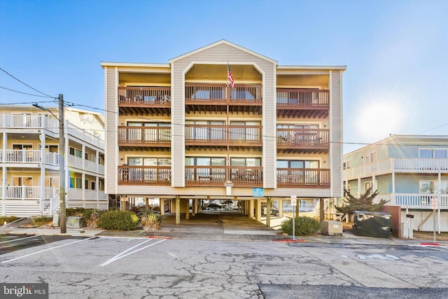 view of building exterior with uncovered parking