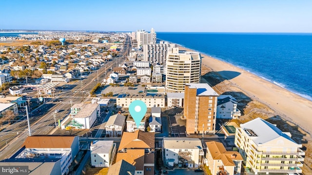 aerial view featuring a water view, a view of city, and a beach view