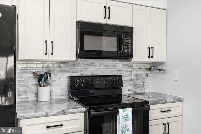 kitchen featuring white cabinetry, black appliances, light stone counters, and decorative backsplash