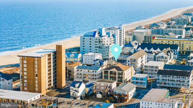 bird's eye view with a water view and a beach view