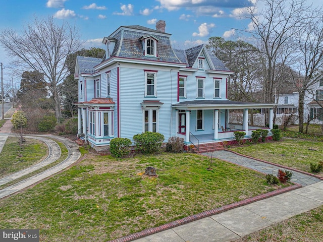 second empire-style home with a front lawn, mansard roof, a high end roof, a porch, and a chimney