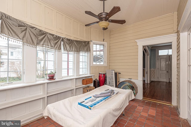 sunroom / solarium with a ceiling fan