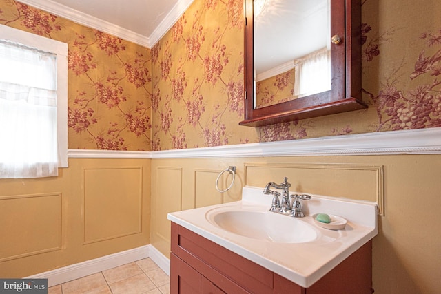 bathroom with vanity, ornamental molding, wainscoting, and wallpapered walls