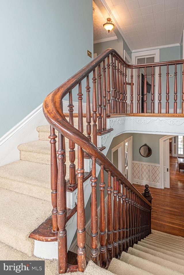 staircase featuring crown molding