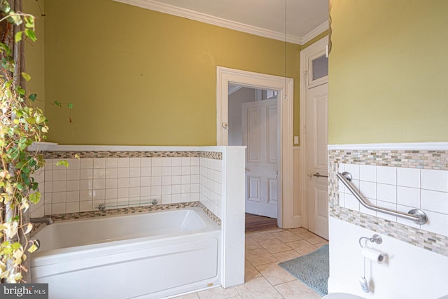 full bathroom with a garden tub, tile walls, wainscoting, crown molding, and tile patterned flooring