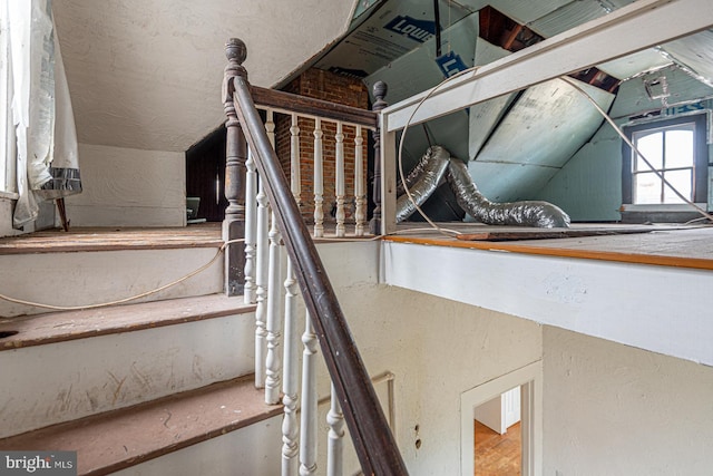 stairs featuring lofted ceiling