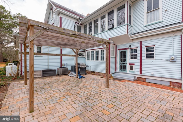 view of patio / terrace featuring area for grilling, a pergola, and entry steps