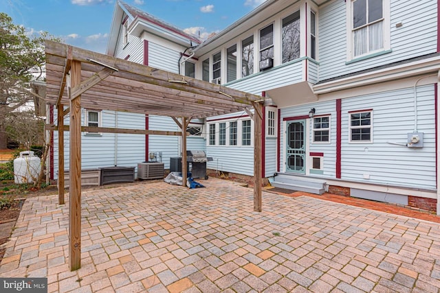 view of patio / terrace with a grill, entry steps, and a pergola