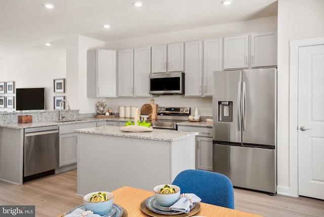 kitchen with recessed lighting, light wood-style floors, appliances with stainless steel finishes, and a sink