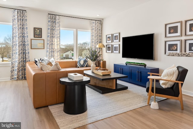 living room featuring light wood-type flooring and baseboards