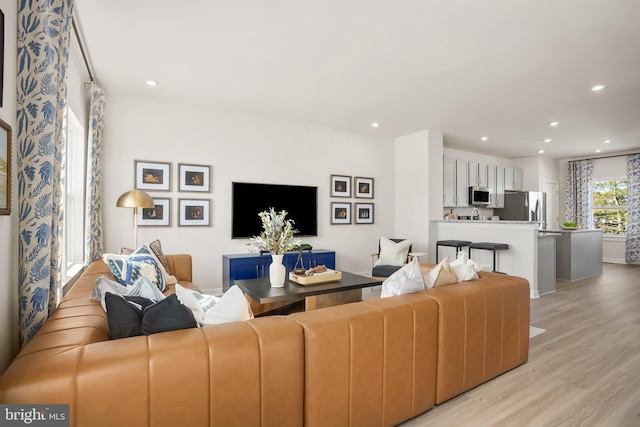 living area featuring recessed lighting and light wood-style floors