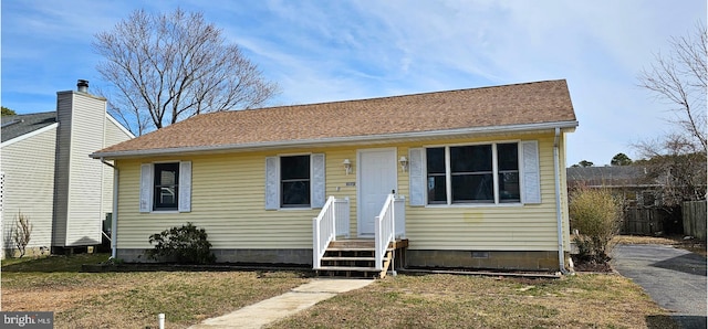 bungalow featuring fence, roof with shingles, and crawl space