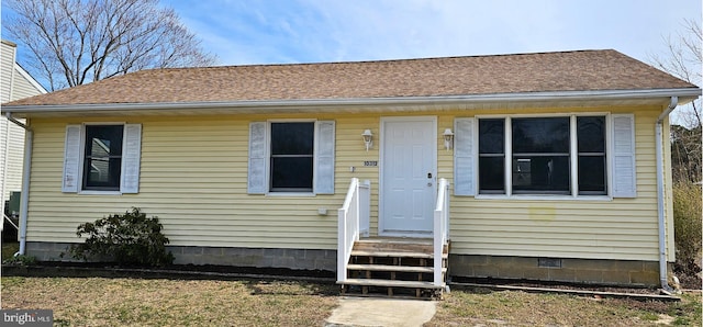 bungalow-style home with roof with shingles and crawl space