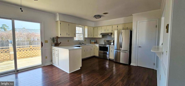 kitchen with dark wood-type flooring, under cabinet range hood, light countertops, ornamental molding, and stainless steel appliances