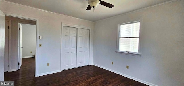 unfurnished bedroom featuring a ceiling fan, baseboards, ornamental molding, dark wood-type flooring, and a closet