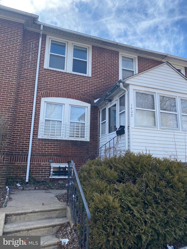 view of front of house featuring brick siding