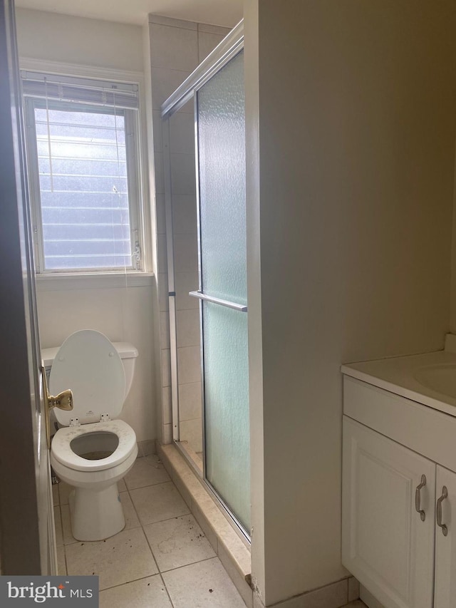 full bath with tile patterned floors, a stall shower, toilet, and vanity