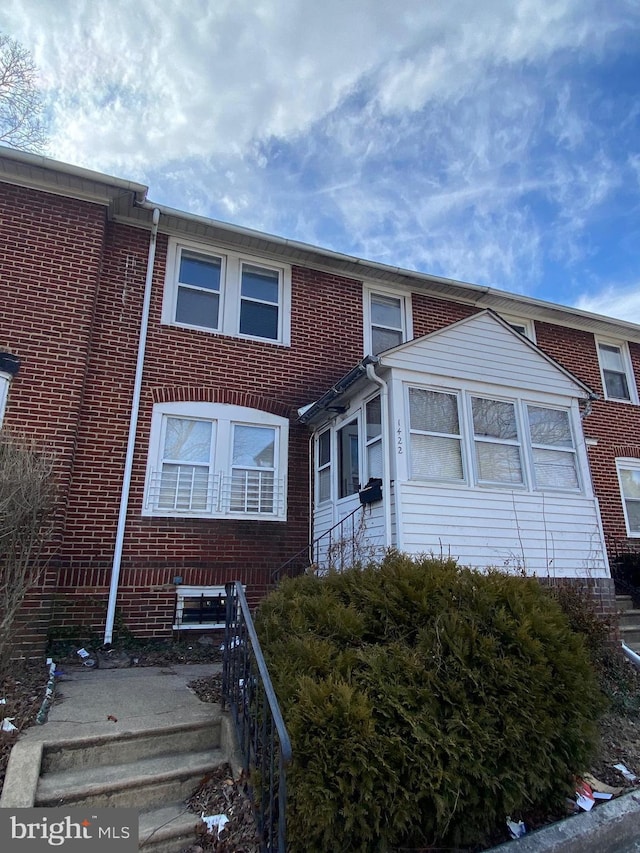 view of property with brick siding