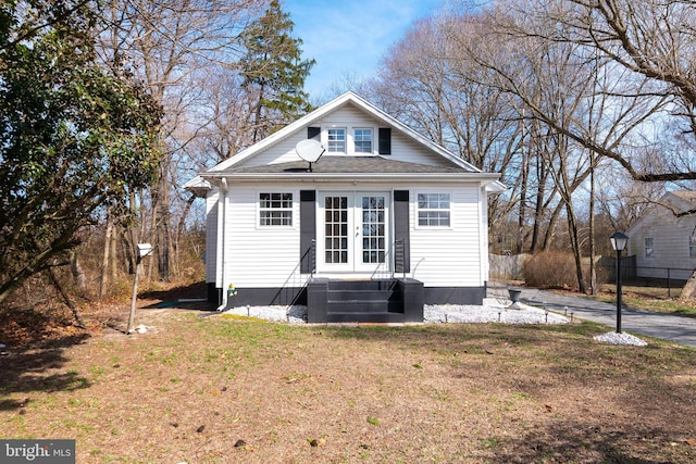 view of front of property with a front lawn, central air condition unit, and french doors