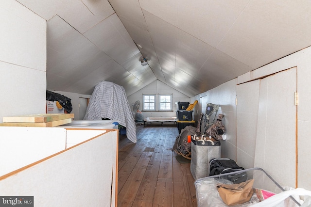 bedroom featuring lofted ceiling and hardwood / wood-style floors