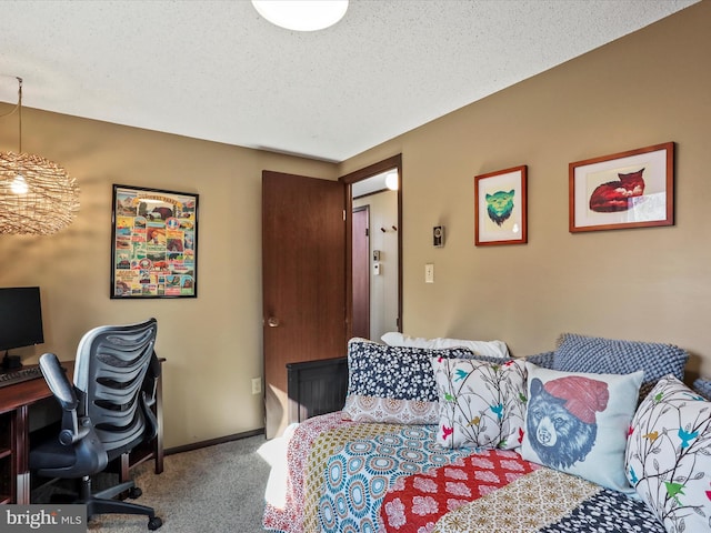 bedroom featuring baseboards, a textured ceiling, and carpet