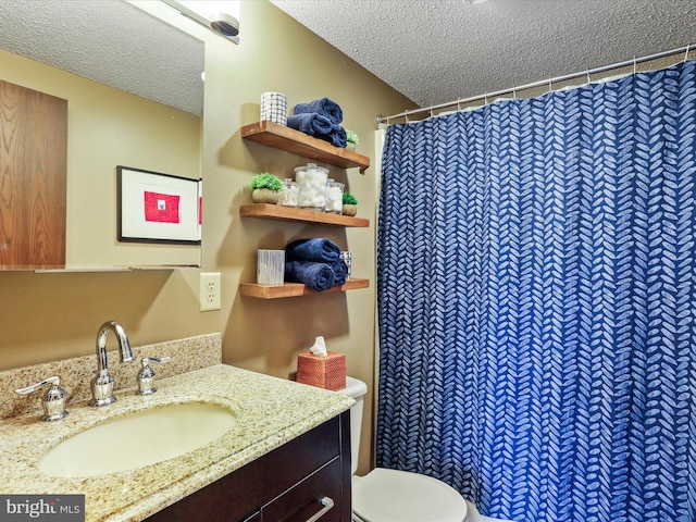 bathroom with curtained shower, a textured ceiling, vanity, and toilet