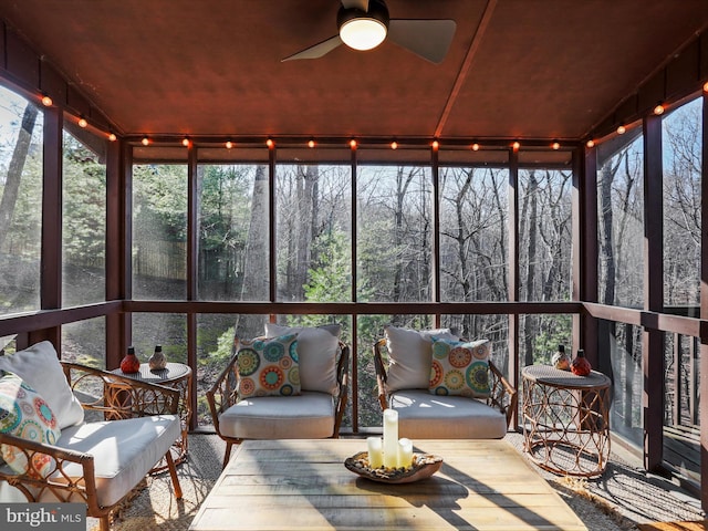 sunroom with a healthy amount of sunlight and ceiling fan