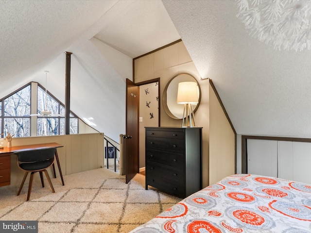 carpeted bedroom with lofted ceiling and a textured ceiling