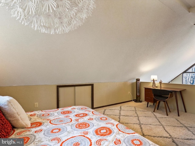 bedroom featuring vaulted ceiling and carpet