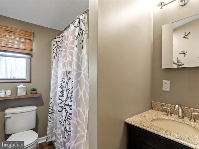 full bath featuring vanity and toilet