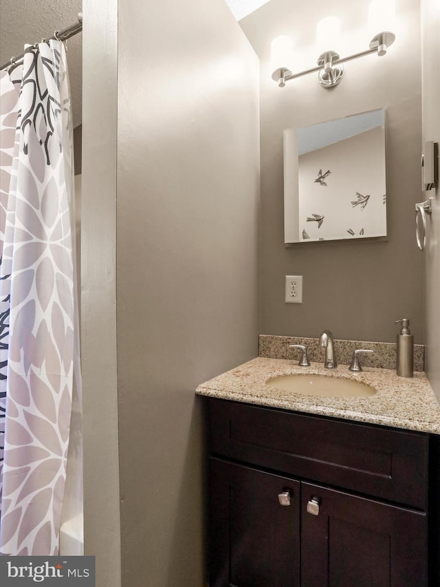 bathroom featuring vanity and shower / bath combo with shower curtain