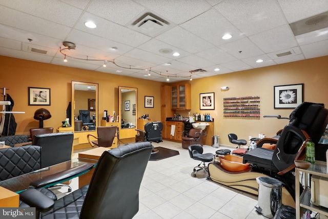 interior space featuring track lighting, visible vents, and a drop ceiling