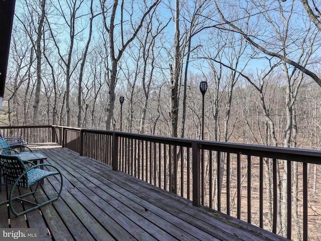 deck featuring a forest view