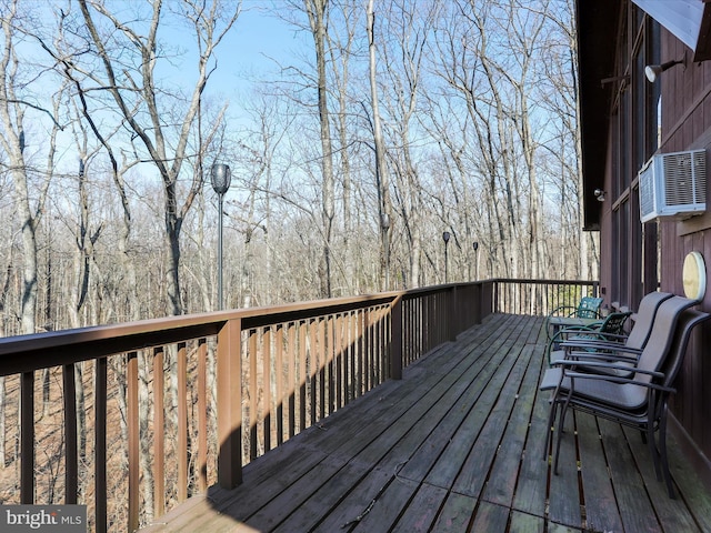 wooden deck with cooling unit and a forest view