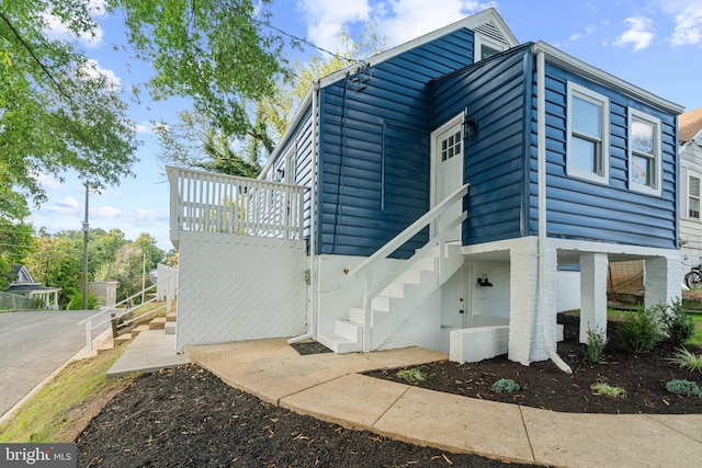 view of home's exterior featuring stairs