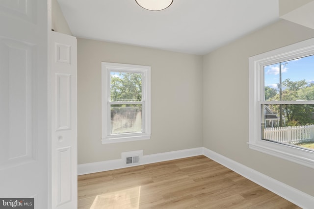 unfurnished room with visible vents, baseboards, and light wood-style floors