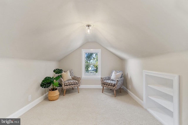 sitting room featuring baseboards, carpet floors, and lofted ceiling