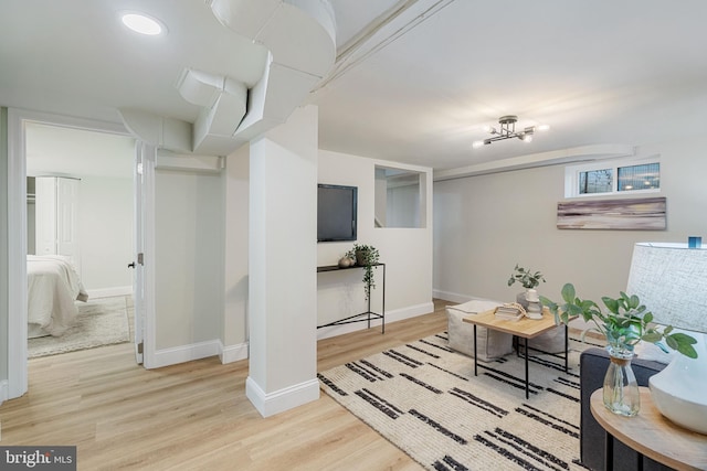 interior space with baseboards and wood finished floors